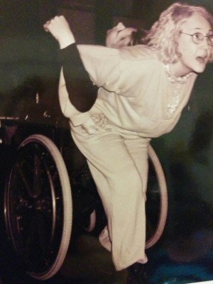 Marye Barton links arms and pulls Spirit Synott, leaning back in her wheelchair. Toronto 1999.